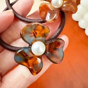 Elegant tortoiseshell flower hair tie with white pearls and brown elastic band