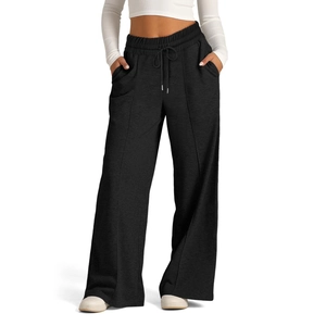 Close-up of black wide-leg drawstring pants with high waist and side pockets