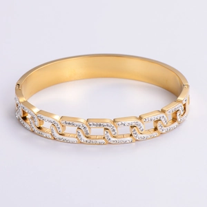 Detailed view of a gold chain-textured bracelet with pavé-set rhinestones and open design