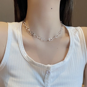 Detailed close-up of a 925 sterling silver long loop geometric necklace on a model