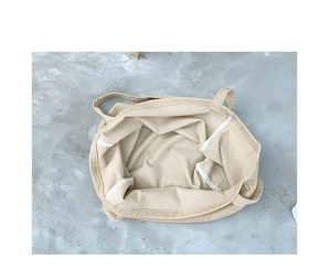 Interior view of beige corduroy tote bag showing spacious storage and reinforced seams