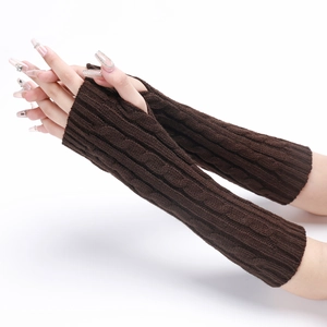 Close-up of brown cable knit fingerless gloves showing thick texture and pattern
