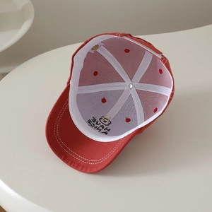 Internal detail of red cotton baseball cap with bear embroidery and white structural strips