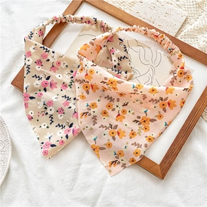 Detail of floral chiffon headbands showing elastic band and delicate fabric texture