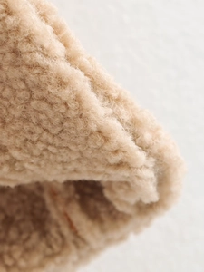 Short faux lamb wool vest in beige featuring a cozy fleece texture and minimalist style