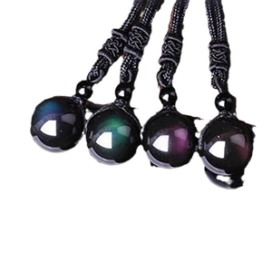 Natural 16mm obsidian bead pendant necklace with black braided cord on white background