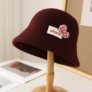 Cute dark red lamb wool bucket hat with a plaid bow decoration for women in winter