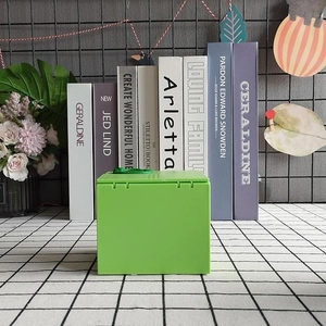Electric dinosaur piggy bank in green cube design placed on a modern tabletop