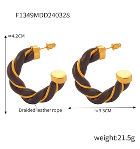 Macro detail of braided leather and golden metal twisted C-shaped earrings with measurements