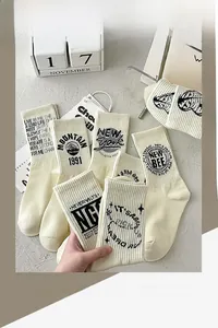 Detailed shot of breathable cotton crew socks with retro patterns and star embroidery