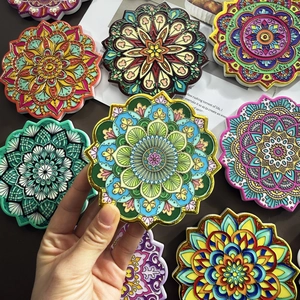 Macro detail of bohemian ceramic mandala coaster with gold foil stamping and embossed patterns