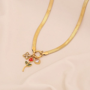 Gold snake chain necklace with red rose flower, four-leaf clover, and heart pendants