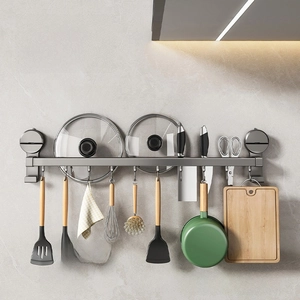 Wall-mounted suction cup kitchen storage rack with hooks, knife holder, and pot lid organizer