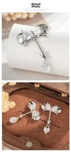 Detailed macro view of bowknot titanium steel stud with sparkling heart shaped zircons