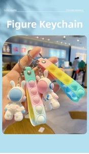 Detail of colorful macaron astronaut keychains with gradient pop-it silicone straps