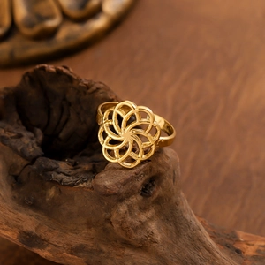 Minimalist gold cutout flower ring with multilayer texture on vintage wood background