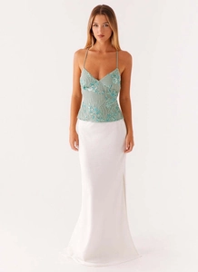 Detailed view of floral beadwork and sequins on a two-piece satin dress set