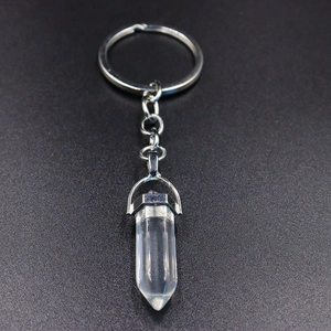 Macro detail of a hexagonal crystal column pendant with a silver metal keychain ring