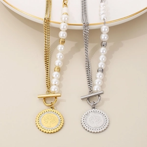 Detail of tree of life pendants on gold and silver half-pearl Cuban link necklaces
