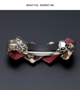 Detail view of large acetate hair clip with marble patterns and silver spring mechanism