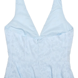 Detail view of the light blue dress featuring a V-neck back with a discreet invisible zipper