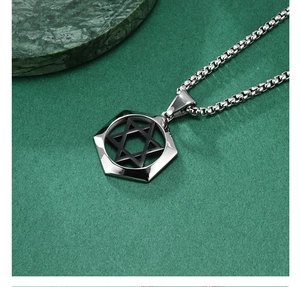 Macro shot of silver stainless steel hexagonal pendant with black hexagram design