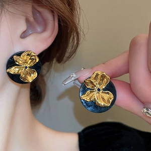 Elegant black resin round earrings with 3D gold floral center in retro aesthetic