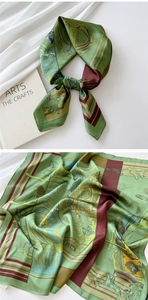Detail of silk scarf showing equestrian patterns with horses and vintage carriage motifs