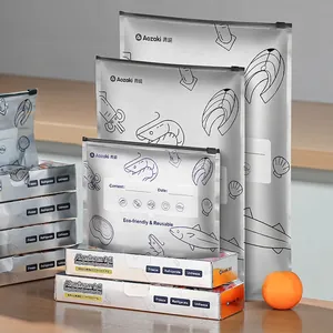Three sizes of aluminum foil food storage bags with zippers on a minimalist wooden table