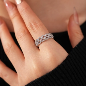 Close-up of 18k gold plated hollow flower ring with cubic zirconia stones on hand