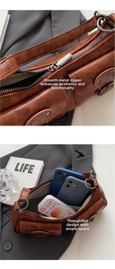 Detailed view of brown vintage crescent bag interior capacity and metal zipper texture