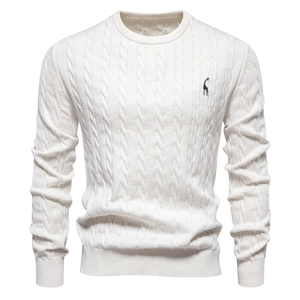 Close-up of white cable knit sweater featuring minimalist giraffe embroidery on the chest
