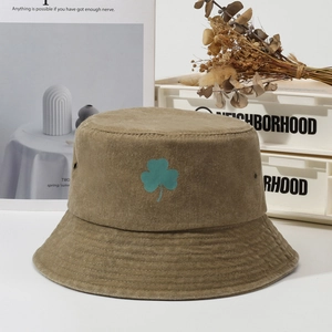 Vintage olive green corduroy bucket hat with embroidered teal shamrock clover design