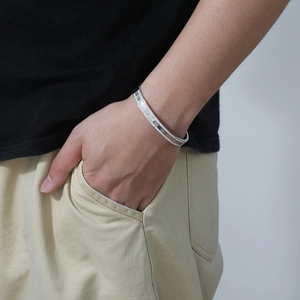 Detailed view of silver roman numeral bangle featuring a single row of sparkling crystals