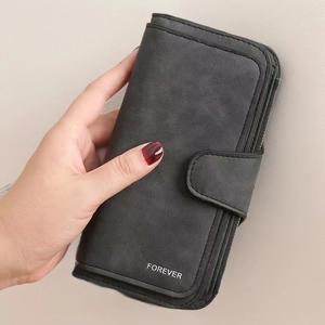 Detail of black matte leather long wallet with FOREVER logo and secure zipper closure