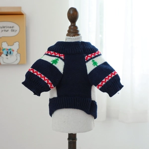 Detailed view of navy blue knitted pet sweater with festive Christmas tree patterns