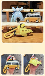 Detail of cartoon leather plane and bus keychains with woven lanyards and metal clips