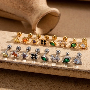 Macro display of assorted zircon-studded stainless steel screw ball ear studs in gold and silver