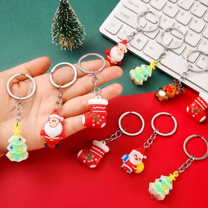 Creative Christmas PVC keychains featuring Santa Claus and reindeer on festive background