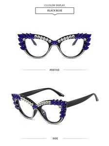 Detail view of black cat-eye glasses frame with blue marquise rhinestones and white crystals