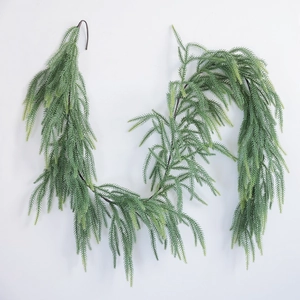 Close-up of realistic Norfolk pine garland with soft-touch needles and green texture