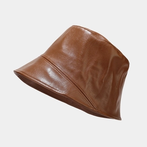 Detailed view of the dark brown PU leather bucket hat with glossy finish and fine texture