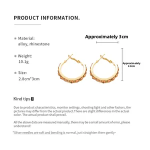 Detail view of gold alloy hoop earrings with sparkling rhinestones and exact measurements