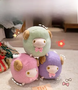 Three colorful round plush sheep toys in pastel green, pink and purple with curly horns