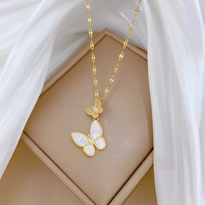 Detail of butterfly necklace with mother of pearl shell and zirconia on gold petal chain