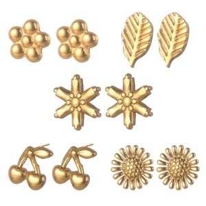 Golden multi-element stud earring set featuring floral, star, and leaf designs on white