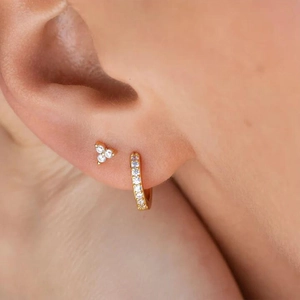 Detailed view of 925 silver gold-plated stud and hoop earrings with sparkling zircon