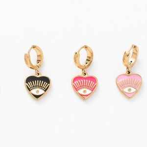 Detailed view of heart-shaped evil eye drop earrings in black, magenta and pink gold metal