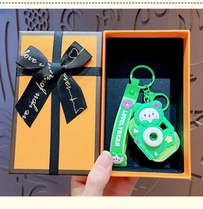 Green cartoon bear camera keychain with lanyard in an elegant orange gift box