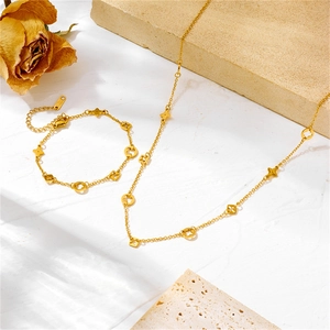 Golden clover jewelry set featuring four-leaf clover pendant necklace and bracelet